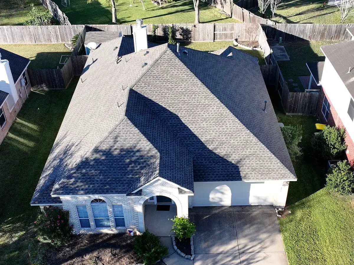 Aerial view of a home with a finished gray shingle roof