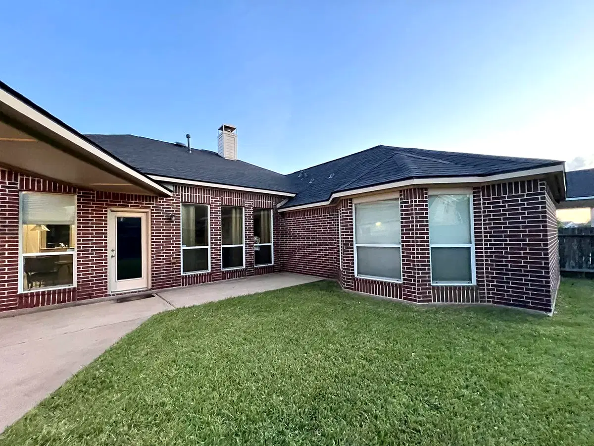 Brick home with a dark asphalt-shingle roof