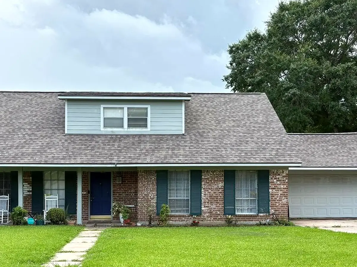 Front of a residential home with a completed shingle roof