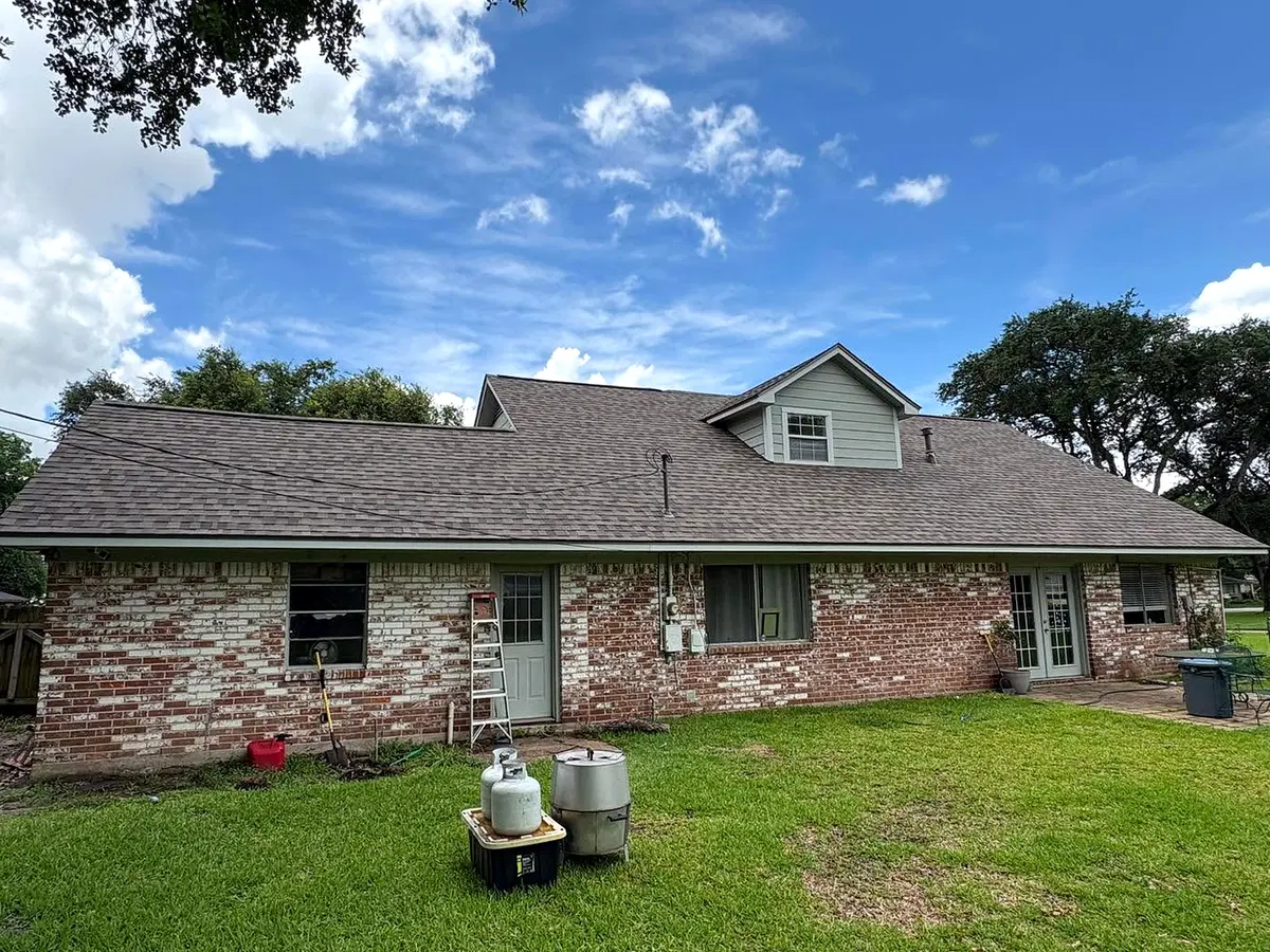 Residential brick home with gray asphalt shingles
