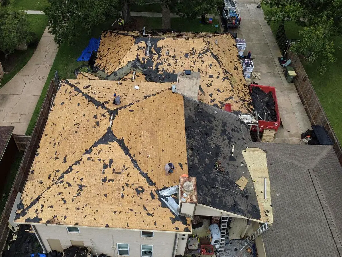 Roof replacement in progress with wood roof decking exposed